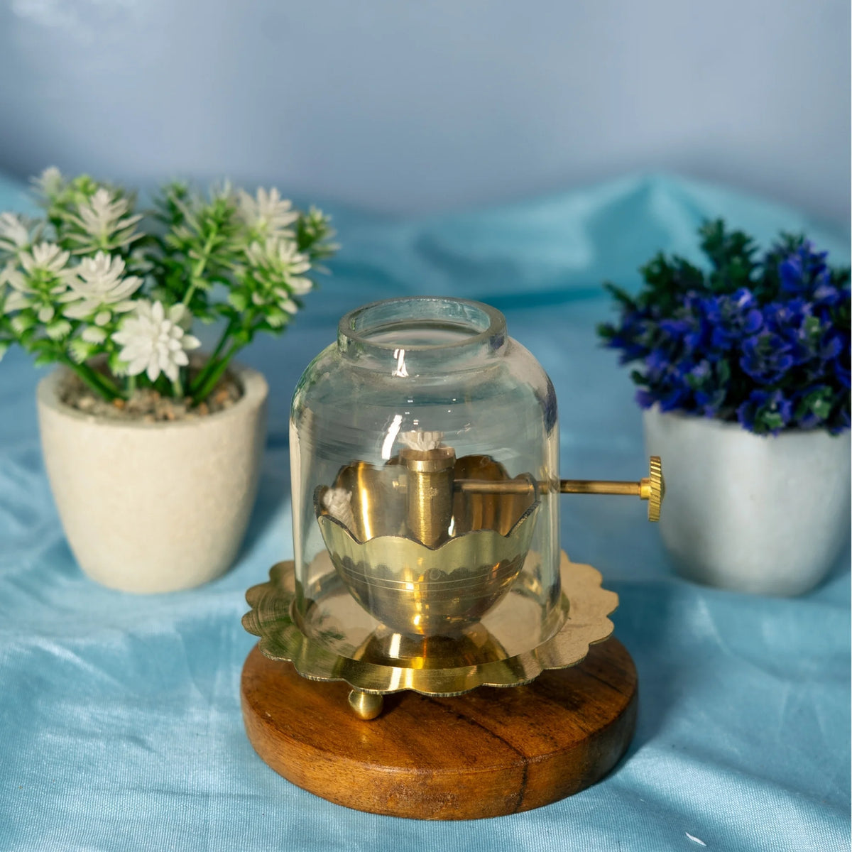 Brass Akhand Jyot diya with clear glass cover, adjustable bati knob and wooden base