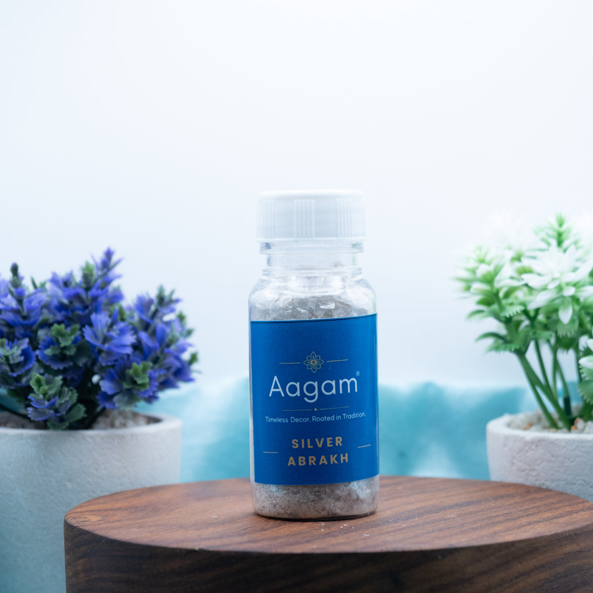 Aagam silver abhrak mica pooja samagri in a small labelled bottle on a wooden stand
